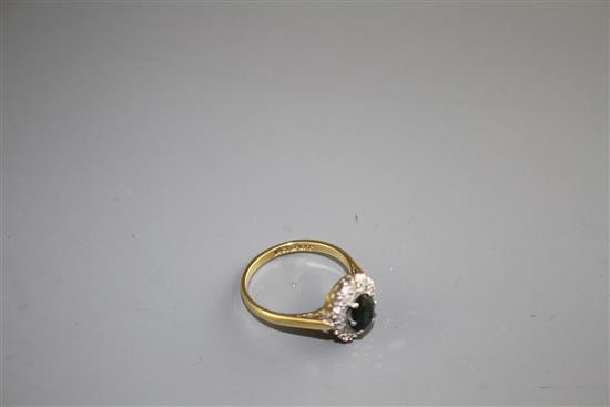 An 18ct and Plat, sapphire and illusion set diamond oval cluster ring, size M, gross weight 3.5 grams,